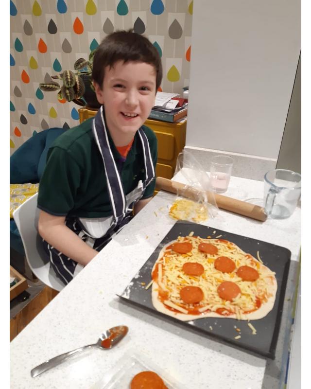 Cub at table with his pizza